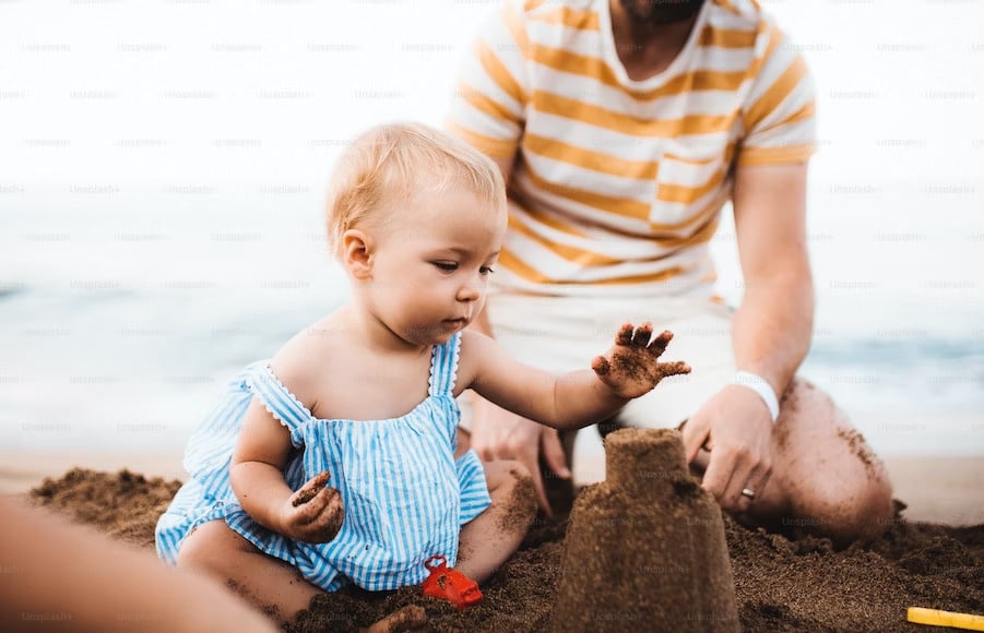 Baby marvels at Normandy beach, discovering the beauty of nature
